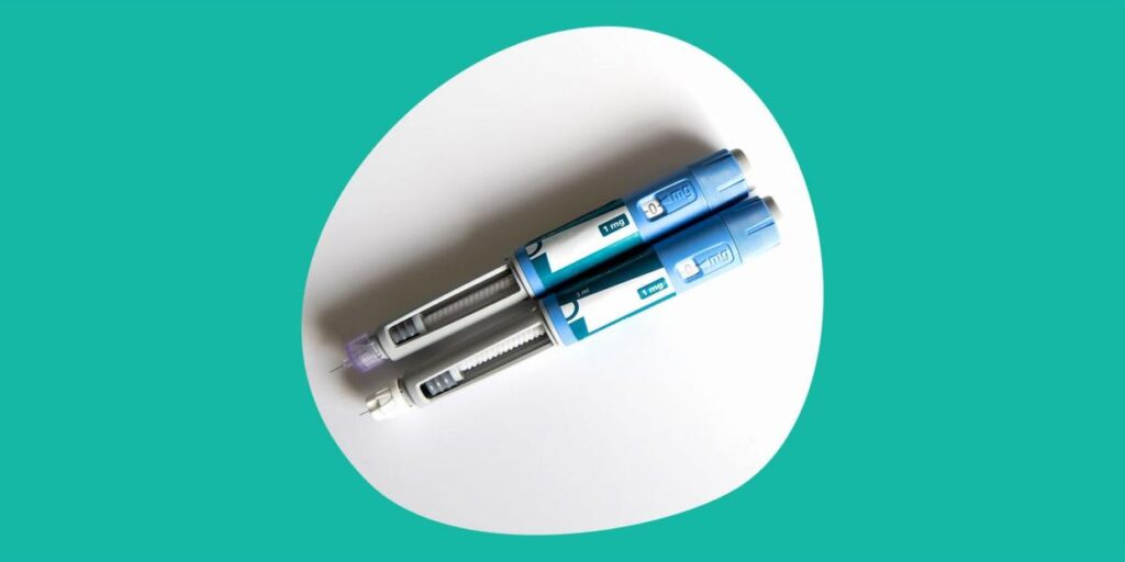 two osempic pens on a blue-green ground